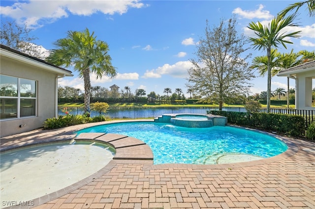 view of swimming pool featuring a water view and an in ground hot tub