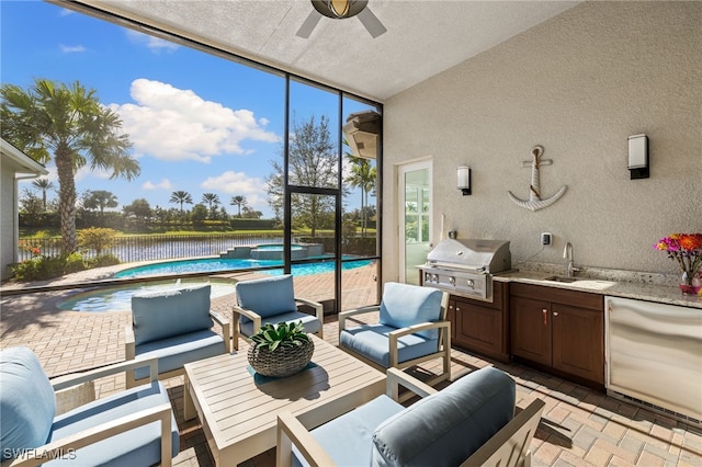 sunroom / solarium with ceiling fan, sink, a water view, and vaulted ceiling