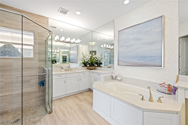 bathroom featuring vanity and shower with separate bathtub