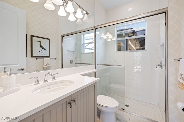 bathroom featuring an enclosed shower, vanity, toilet, and tile patterned flooring