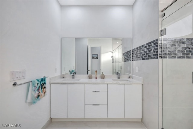 bathroom with a shower with door and vanity