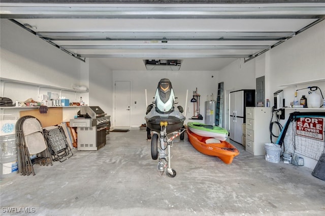 garage featuring electric water heater and electric panel