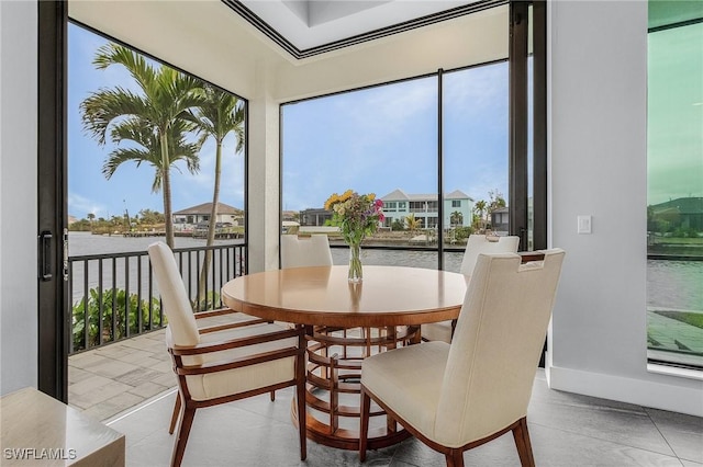 tiled dining room featuring a water view