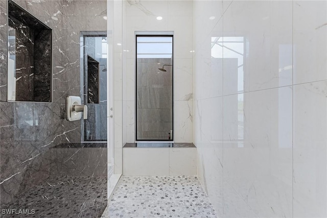 bathroom with tiled shower