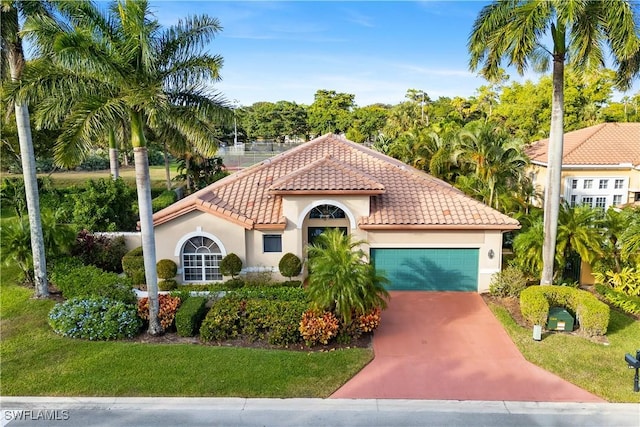 mediterranean / spanish home with a garage