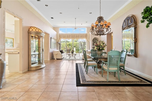 tiled dining area featuring a towering ceiling, ornamental molding, and a notable chandelier