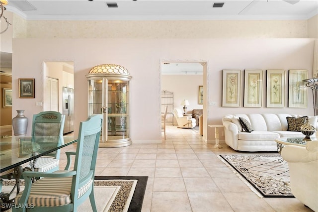 living room featuring light tile patterned floors and crown molding