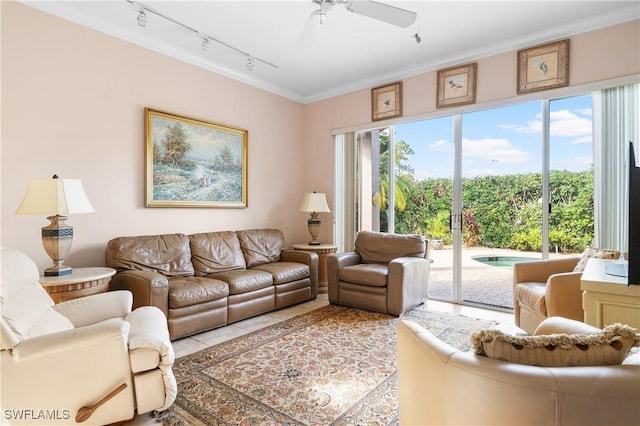 tiled living room featuring ceiling fan, ornamental molding, and rail lighting