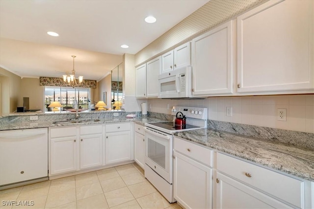 kitchen featuring white cabinetry, sink, a chandelier, white appliances, and light tile patterned flooring