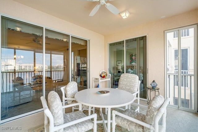 sunroom / solarium featuring ceiling fan