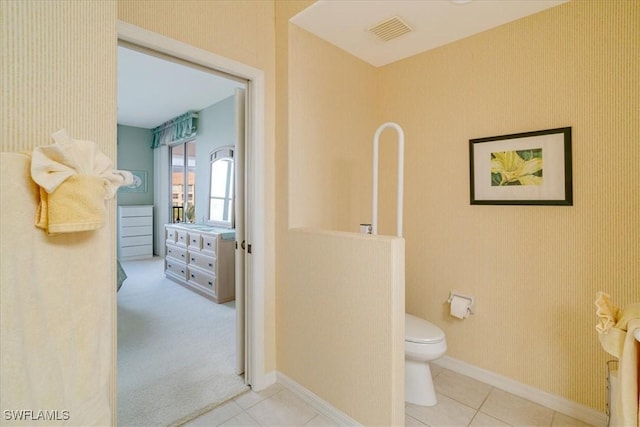 bathroom with tile patterned flooring and toilet