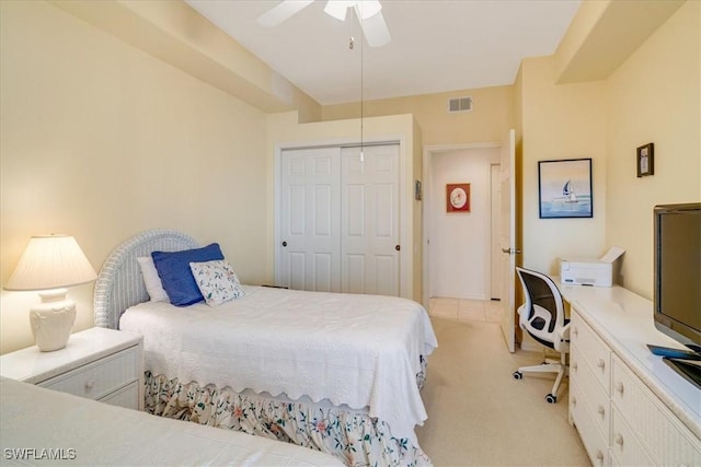 bedroom featuring light carpet, a closet, and ceiling fan