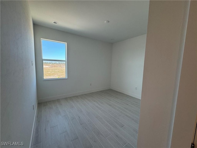 spare room featuring light hardwood / wood-style floors