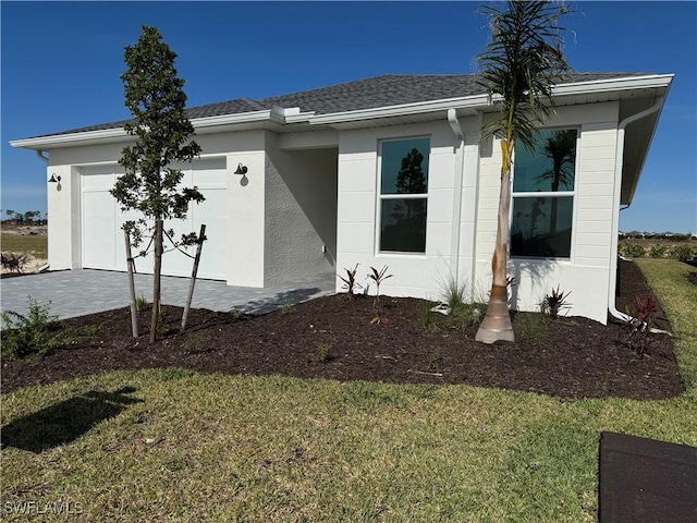 view of front of house with a garage and a front lawn