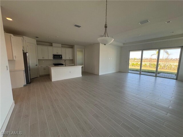 unfurnished living room with sink