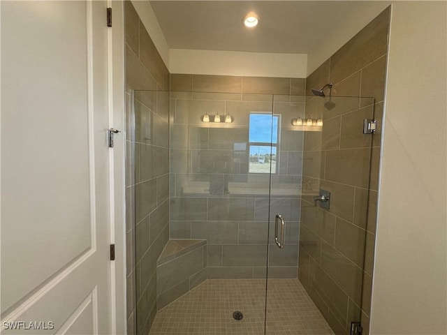 bathroom featuring a shower with door