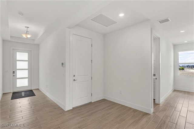 44488 Little Blue Heron Way, Punta Gorda, FL 33982 - foyer with light wood-type flooring, baseboards, and recessed lighting