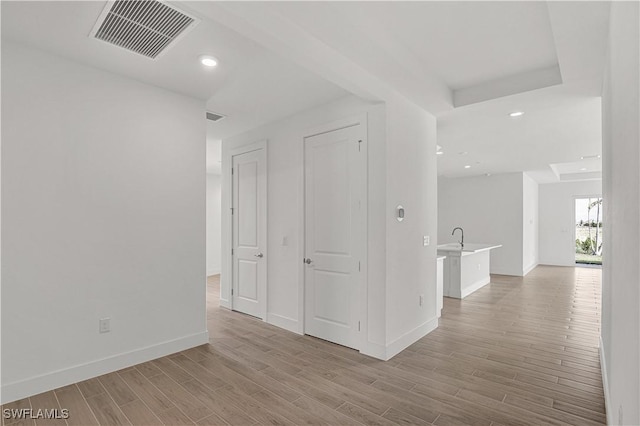 44488 Little Blue Heron Way, Punta Gorda, FL 33982 - hall featuring light wood finished floors, baseboards, and recessed lighting