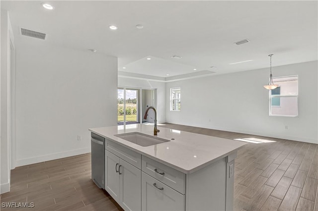 44488 Little Blue Heron Way, Punta Gorda, FL 33982 - kitchen with a sink, wood finished floors, stainless steel dishwasher, open floor plan, and recessed lighting