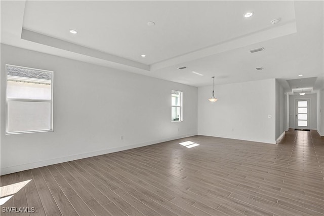 44488 Little Blue Heron Way, Punta Gorda, FL 33982 - spare room featuring light wood-style floors, baseboards, a raised ceiling, and recessed lighting