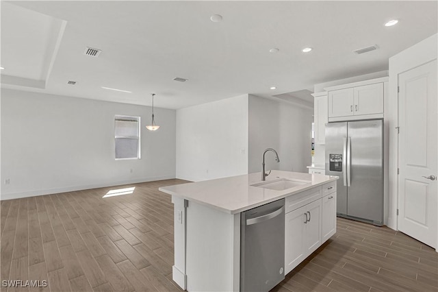 44488 Little Blue Heron Way, Punta Gorda, FL 33982 - kitchen with appliances with stainless steel finishes, a sink, wood tiled floors, recessed lighting, and a kitchen island with sink