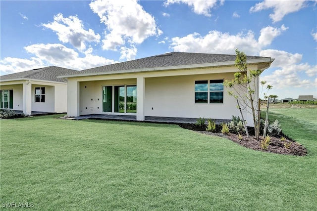 44488 Little Blue Heron Way, Punta Gorda, FL 33982 - back of house featuring a yard and stucco siding
