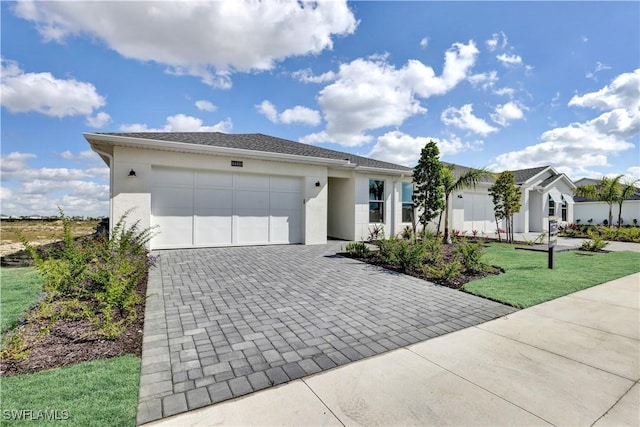 44488 Little Blue Heron Way, Punta Gorda, FL 33982 - ranch-style home with decorative driveway, a garage, stucco siding, and a front lawn