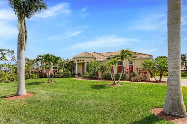 mediterranean / spanish-style home with a front yard