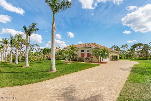 mediterranean / spanish home with a front yard