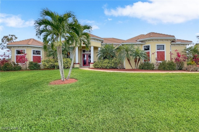 mediterranean / spanish-style home with a front yard