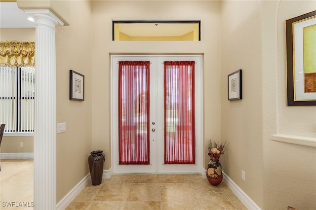 foyer featuring french doors and ornate columns