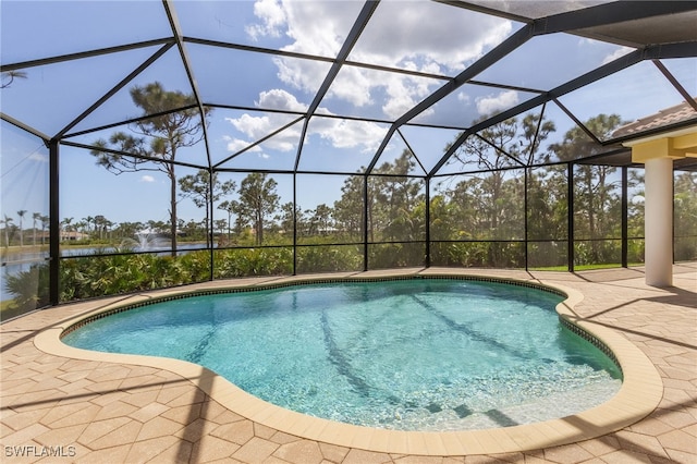 view of swimming pool with a lanai and a patio