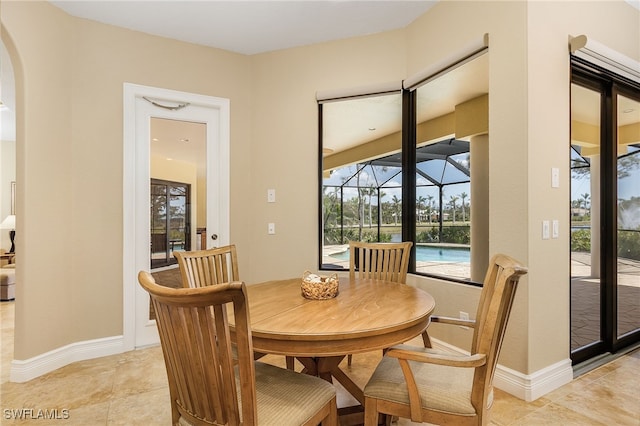 dining space featuring light tile patterned flooring