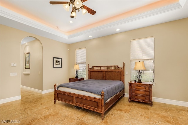 bedroom with ceiling fan, crown molding, and a tray ceiling