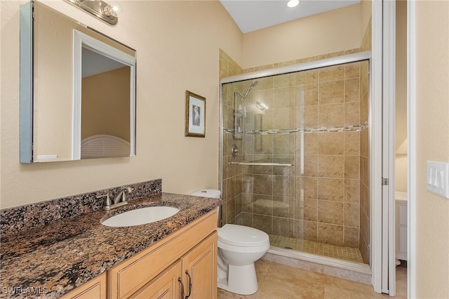 bathroom featuring walk in shower, tile patterned flooring, vanity, and toilet