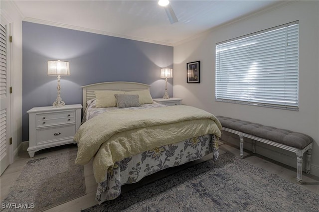 bedroom with ceiling fan and ornamental molding