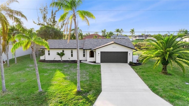 single story home featuring a garage and a front lawn