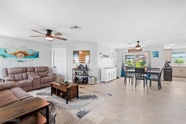 living room featuring a wealth of natural light and ceiling fan