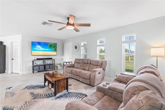 tiled living room featuring ceiling fan