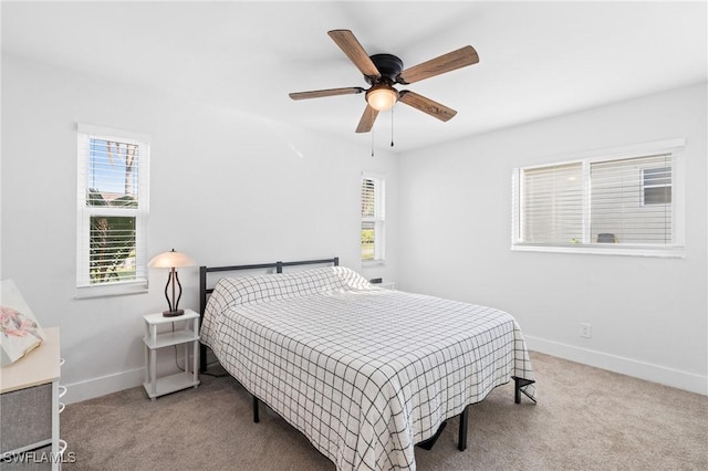 bedroom featuring multiple windows, ceiling fan, and carpet floors