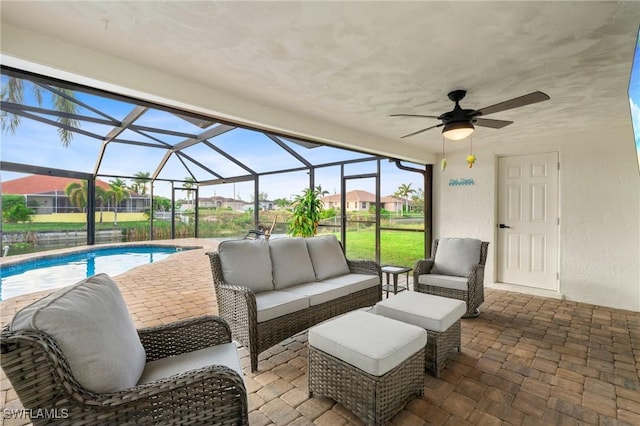 view of patio with a lanai, outdoor lounge area, and ceiling fan