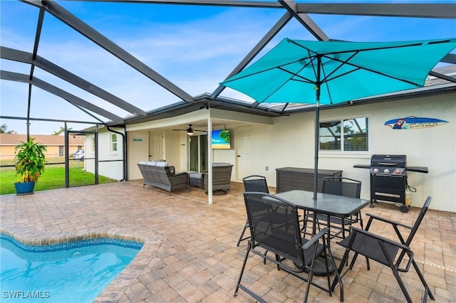 view of pool with a lanai, ceiling fan, and a patio area