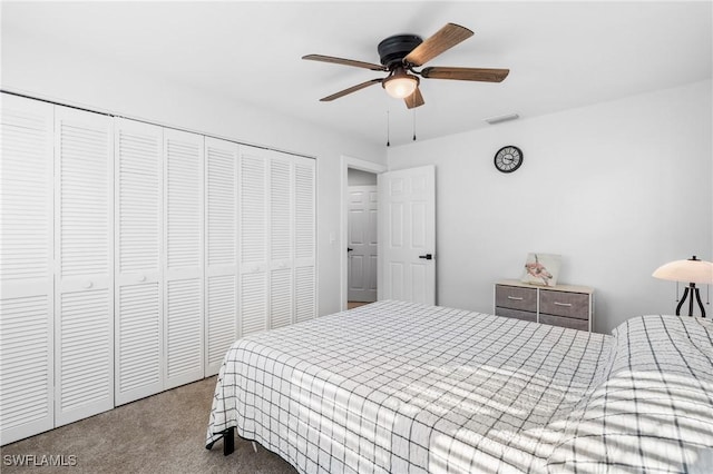 carpeted bedroom with ceiling fan and a closet