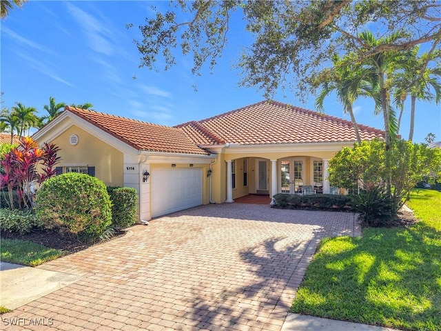 mediterranean / spanish house with a garage and a porch