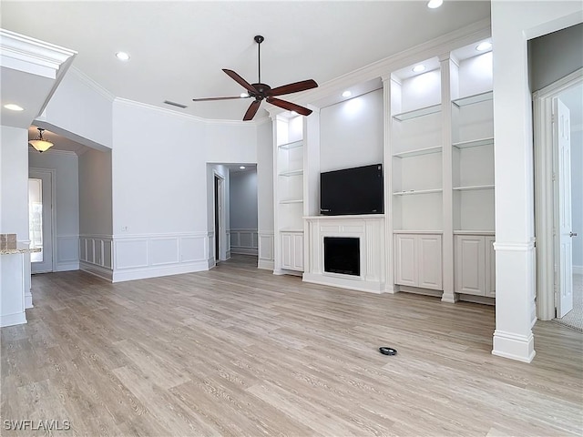 unfurnished living room featuring built in shelves, ornamental molding, light hardwood / wood-style floors, and ceiling fan