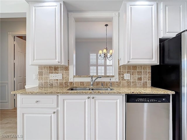 kitchen featuring sink, stainless steel dishwasher, pendant lighting, light stone countertops, and white cabinets