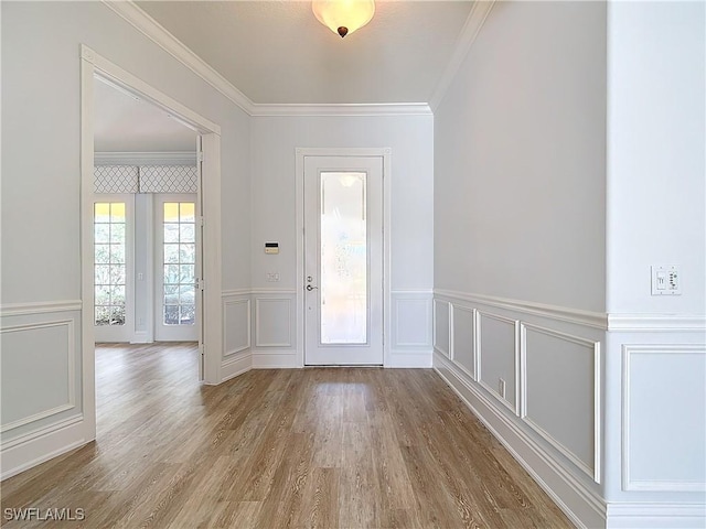 entryway featuring hardwood / wood-style flooring and crown molding