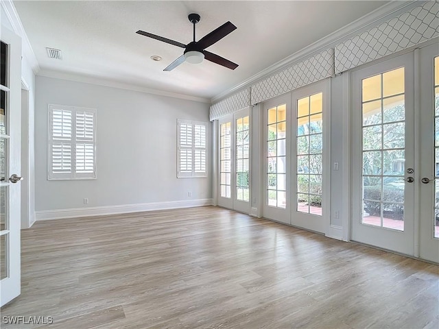 empty room featuring crown molding, ceiling fan, and light hardwood / wood-style floors