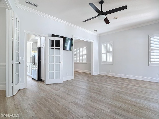 unfurnished room with crown molding, ceiling fan, and light wood-type flooring