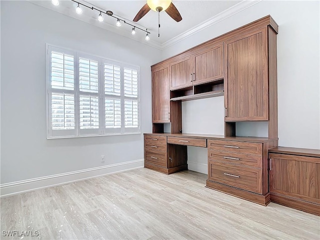 unfurnished office with crown molding, built in desk, ceiling fan, and light hardwood / wood-style flooring